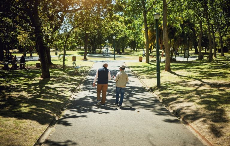 Friends,,Men,Walking,And,Talking,In,Park,,Nature,And,Outdoor