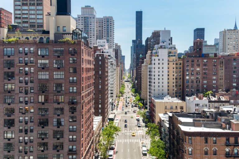 Overhead,View,First,Avenue,With,Traffic,Drivings,Through,The,Buildings