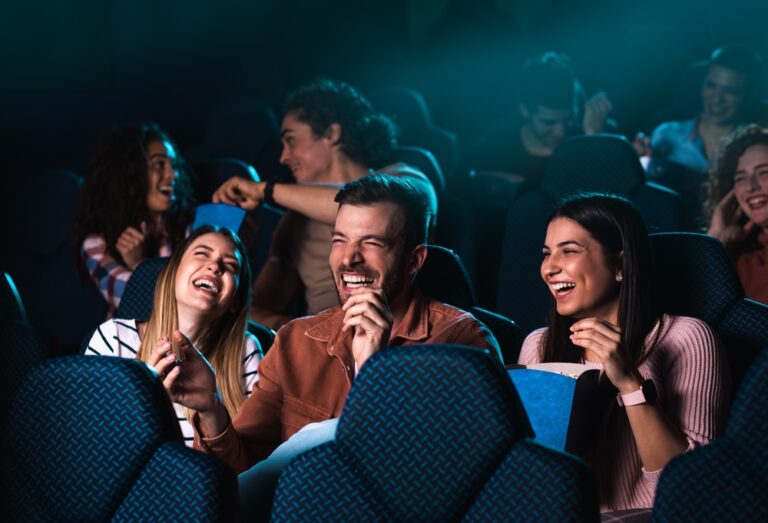 Group,Of,Cheerful,People,Laughing,While,Watching,Movie,In,Cinema