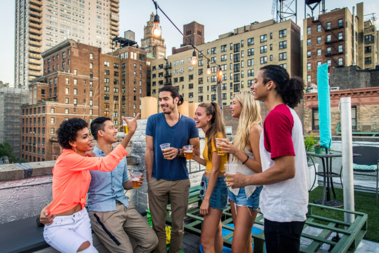 Young,Happy,People,Having,A,Barbecue,Dinner,On,A,Rooftop