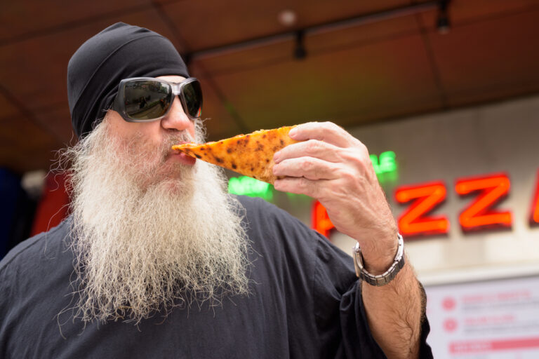 Mature,Bearded,Man,Eating,New,York,Style,Pepperoni,Pizza,Outdoors