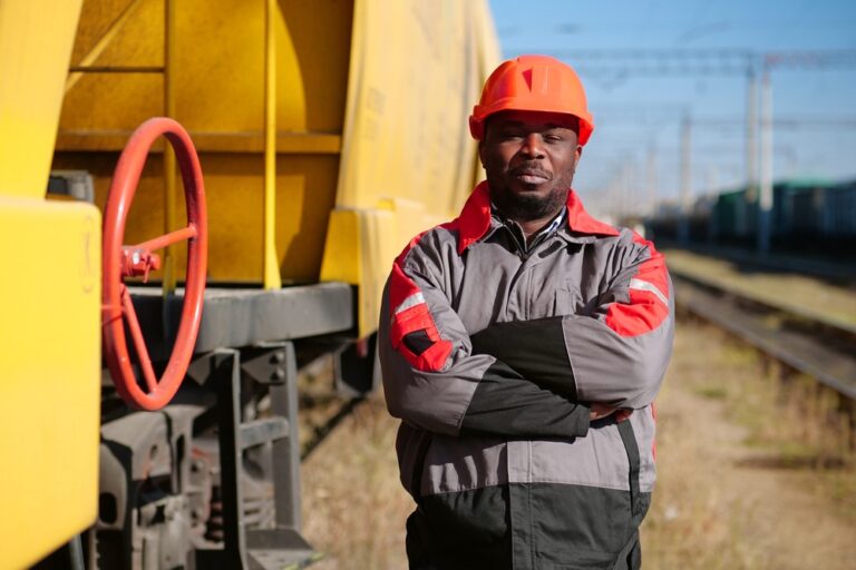 African,American,Railway,Worker,Stands,At,Freight,Train,Terminal