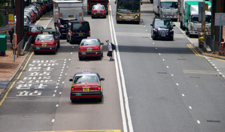 A,Man,Jaywalking,In,The,Busy,Road,Of,Hong,Kong