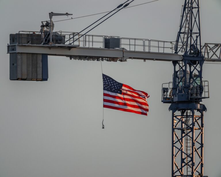 United,States,Flag,Gracefully,Flying,,Back,Lit,By,Setting,Sun