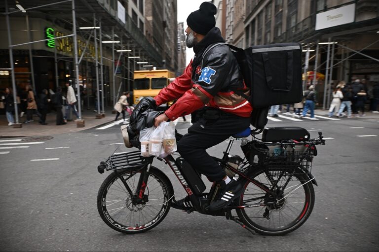 A,Cycle,Courier,Rides,Along,A,Midtown,Manhattan,Street,On