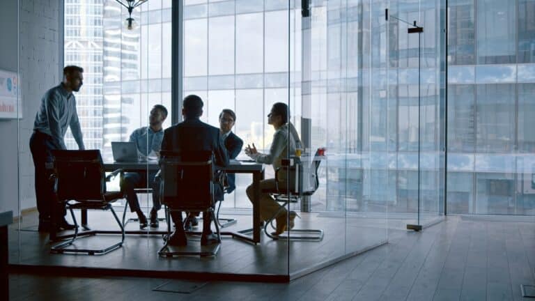 Business,People,Listening,The,Presenter,While,Sitting,At,Desk