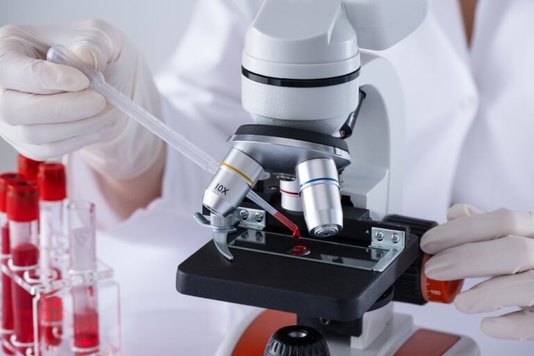A,Scientist,Is,Using,A,Microscope,To,Examine,A,Blood