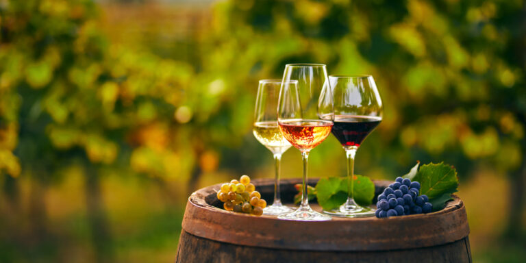 Three,Glasses,With,White,,Rose,And,Red,Wine,On,A