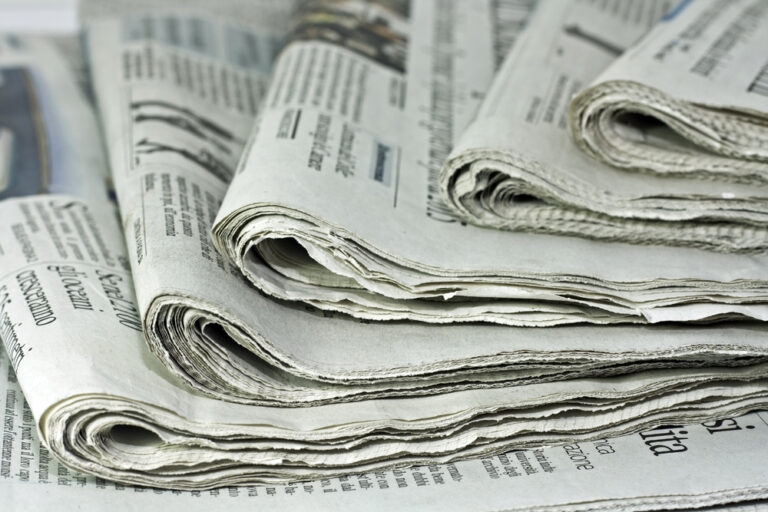 Newspapers,Against,Plain,Background,Shot,With,Very,Shallow,Depth,Of