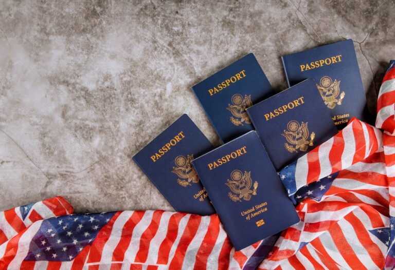 Five,United,States,Passports,Lie,On,Gray,Surface,Beside,American