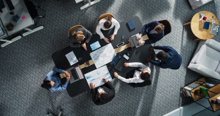 Diverse,Professionals,Working,On,Business,Statistics,Reports,And,Digital,Plans