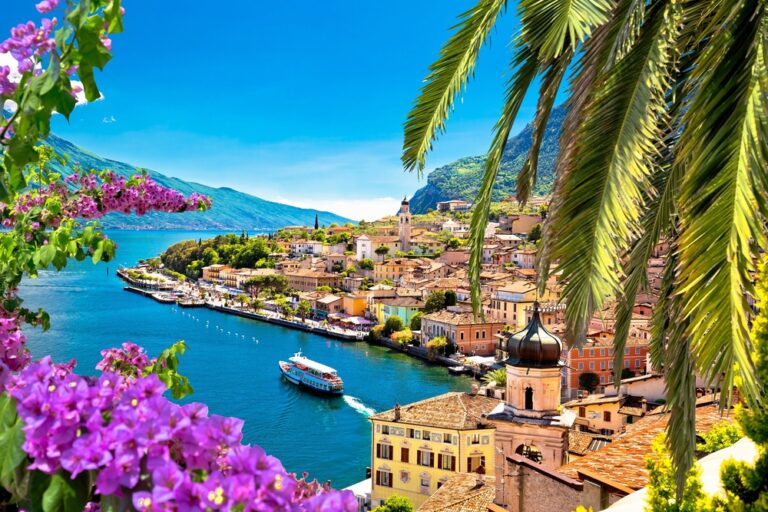 Limone,Sul,Garda,Waterfront,Viewthrough,Flowers,And,Palm,Tree,,Lombardy