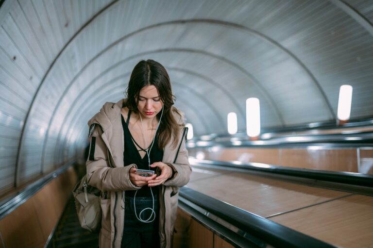 A,Young,Woman,On,An,Escalator,In,The,Subway,With
