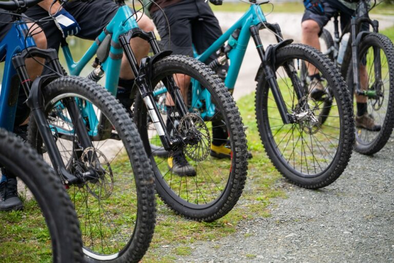 Group,Of,Mountain,Bikers,Lined,Up,With,Teal,Mountain,Bikes